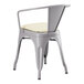 A Lancaster Table & Seating gray metal chair with a white cushion.