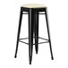 A black bar stool with a white seat.
