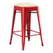 A red Lancaster Table & Seating backless counter height stool with a white cushion.