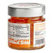 A jar of Toschi Orange Peels in Syrup on a table with a label.