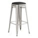 A Lancaster Table & Seating silver metal barstool with a black cushion.