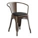 A brown Lancaster Table & Seating restaurant arm chair with black cushion.