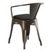 A brown metal Lancaster Table & Seating arm chair with a black cushion.