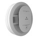 A close-up of a white Kidde smoke and carbon monoxide alarm with a small button.