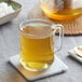 A glass mug of Davidson's Organic Anise Seeds tea on a coaster.