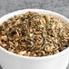 A bowl of Davidson's Organic Ginger Spice Herbal tea leaves.