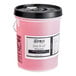 A white 5 gallon bucket of pink Noble Chemical Dry It LF rinse aid with a lid.