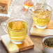 Davidson's Organic Sencha Loose Leaf Tea being poured into a glass cup of tea.