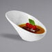 A white APS Minis melamine bowl with brown liquid and cherries in it.