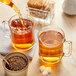 A glass mug filled with Davidson's Organic Decaf Black Loose Leaf Tea.