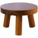 A round wooden stool with three legs.