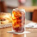 A glass of Diet Pepsi soda with ice on a table.