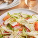 A plate of salad with fennel, oranges, and greens.