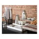 A white Abert Domino buffet podium on a table with a coffee maker and cups.