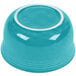 A turquoise bowl with a white rim.