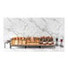 An Abert Revolution riser set holding a tray of pastries on a marble counter.