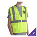 A man wearing a lime green high visibility safety vest.
