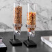 An Abert Cosmo cereal dispenser filled with cereal.