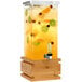 A Rosseto clear acrylic beverage dispenser with fruit in it.