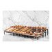 An Abert Revolution riser set with divided tray holding pastries on a table.