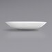 A bright white porcelain plate on a gray background.