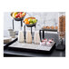 A blue Abert Domino tile display holding bowls of fruit on a hotel buffet table.