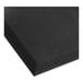 A close up of a black Choice anti-fatigue rubber floor mat with holes in it.