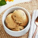 A bowl of Cookie Dough Bliss chocolate chip cookie dough on a table with a spoon.