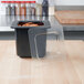 A clear plastic Cambro food pan lid on a container on a counter.