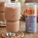 A glass of milk with Rise Brewing Co. Organic London Fog Nitro Oat Milk Latte in it.