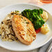 A plate of food with rice, broccoli, and Gardein Plant-Based Chick'n Breast.