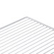 A close up of a Traulsen wire shelf with a white background.