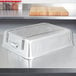 A silver rectangular Vollrath aluminum roaster pan on a counter.