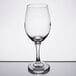 A close-up of a Libbey Perception wine glass on a reflective surface.