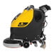 A yellow and black Tornado walk behind floor scrubber with wheels and a handle.