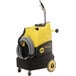 A yellow and black Tornado Surge 220 carpet extractor with hoses.