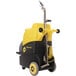 A yellow and black Tornado Surge 220 carpet extractor machine with wheels and a handle.