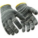 A pair of RefrigiWear knit glove liners with yellow stripes.