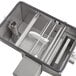 A Grease Guardian automatic grease trap with metal parts and a white interior.