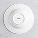 A white Acopa porcelain bowl with an embossed circle on the rim.