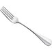 An Amefa stainless steel table fork with a silver handle and four prongs.