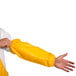A person wearing a yellow Tingley Iron Eagle protective sleeve.