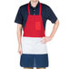 A man wearing a red white and blue Intedge bib apron with one pocket.