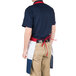 A man in a red, white, and blue apron with one pocket.