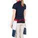 A woman wearing a red, white, and blue striped Intedge bib apron with one pocket.