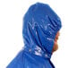 A man wearing a blue Tingley Iron Eagle raincoat with a hood.