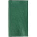 A hunter green paper napkin.