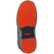 The orange Tingley Flite Safety Non-Slip-Loc sole of a shoe.