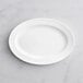 An Acopa Cordelia white porcelain platter on a white surface.