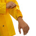 A person wearing a Tingley yellow Iron Eagle rain jacket with inner cuff.